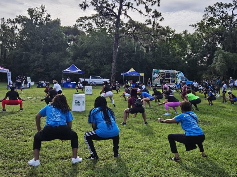People stretching in field before race