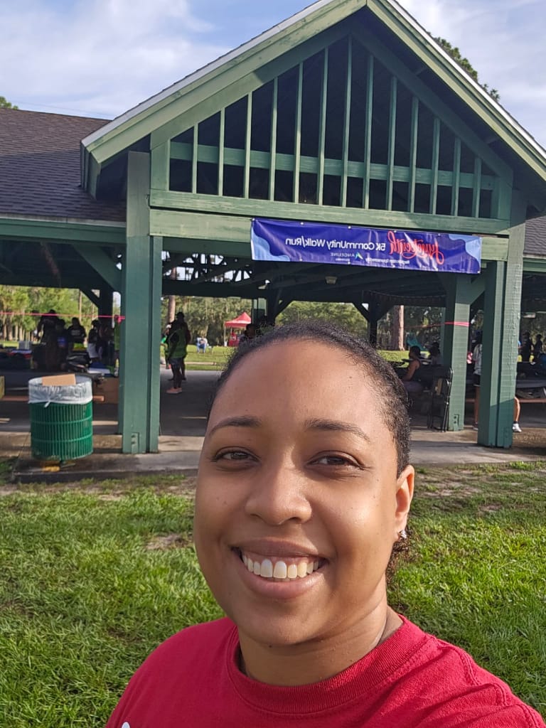 Dr. Tomlinson smiling in foront of a gazebo