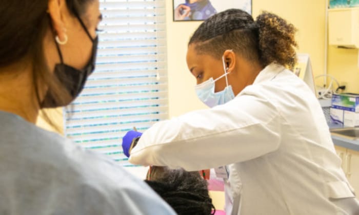 Another dentist working on patient